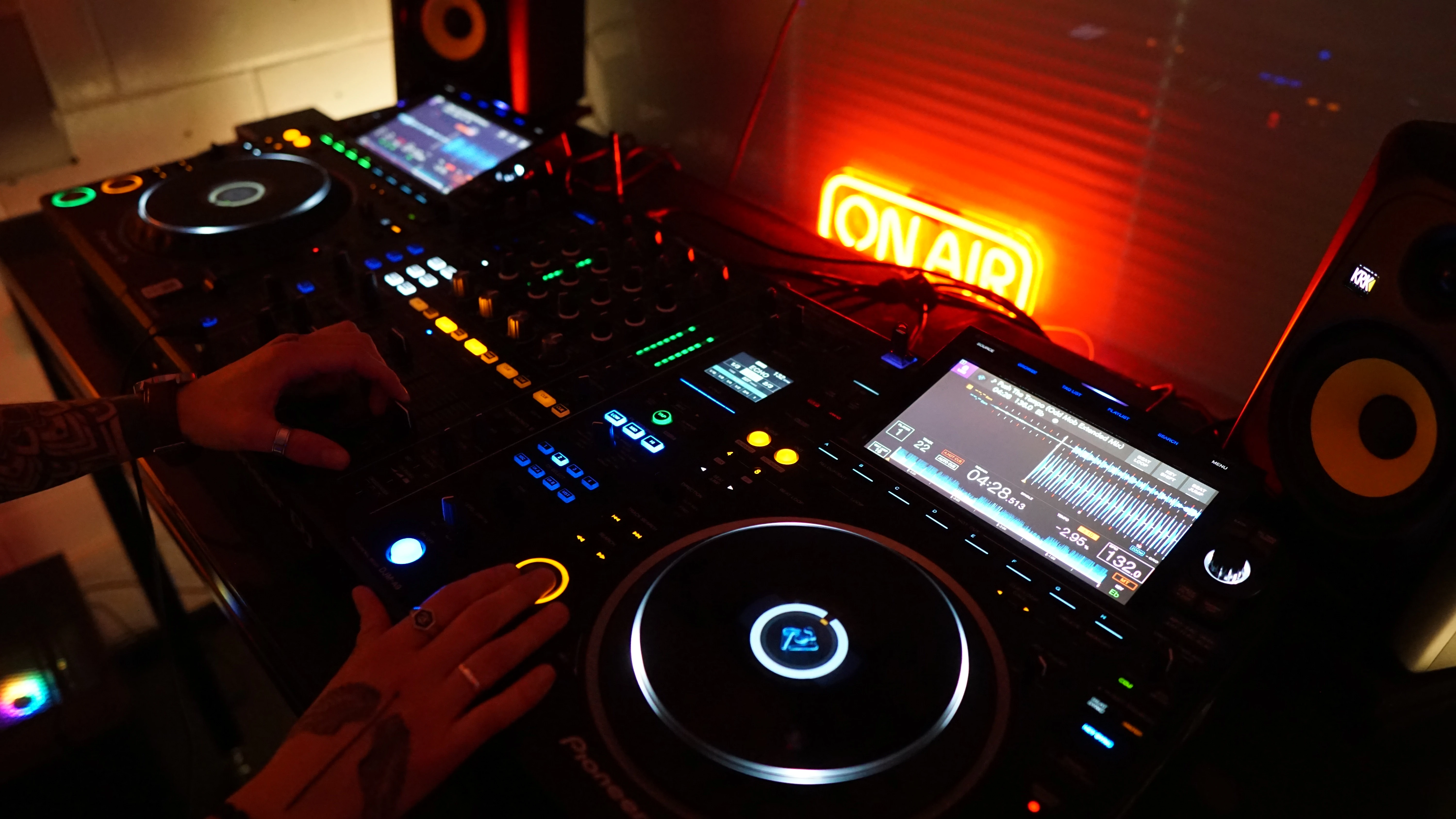The booth — CDJ-3000s under the ON AIR neon